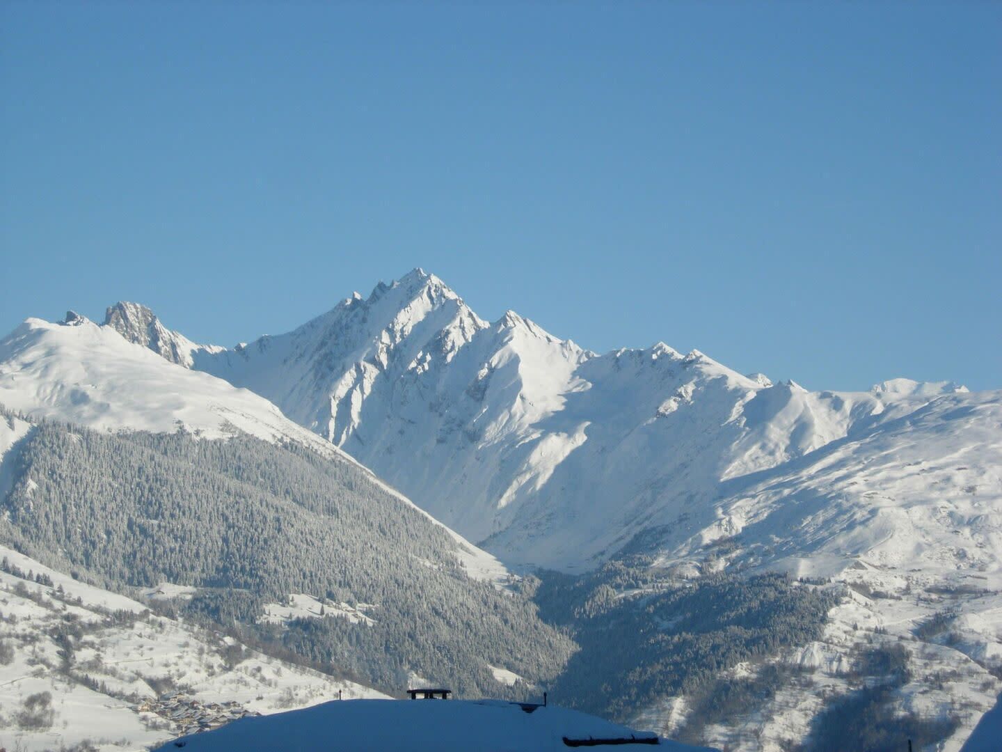 A snow-covered mountain range with a clear sky.