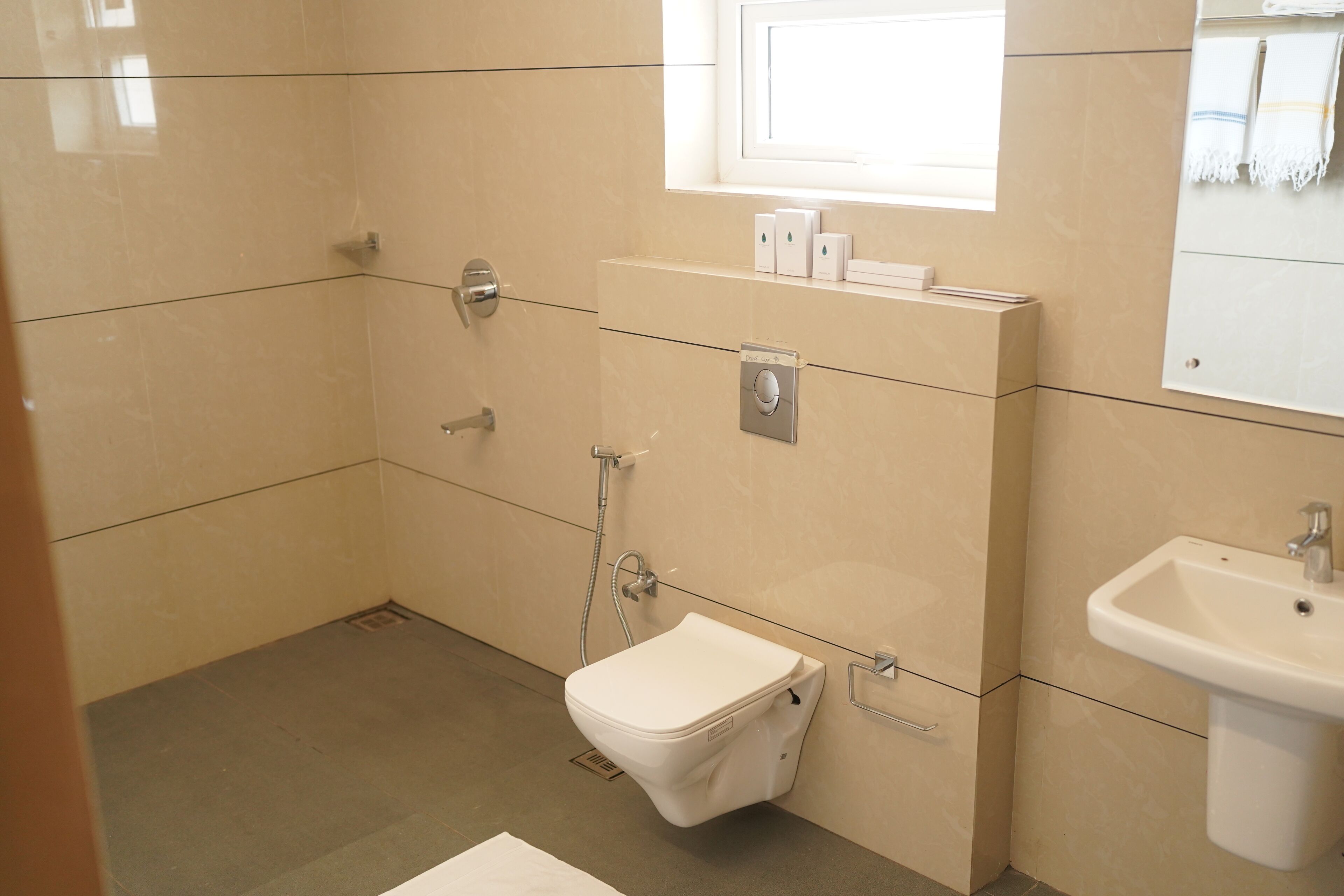A modern bathroom with a toilet, bidet, and sink.