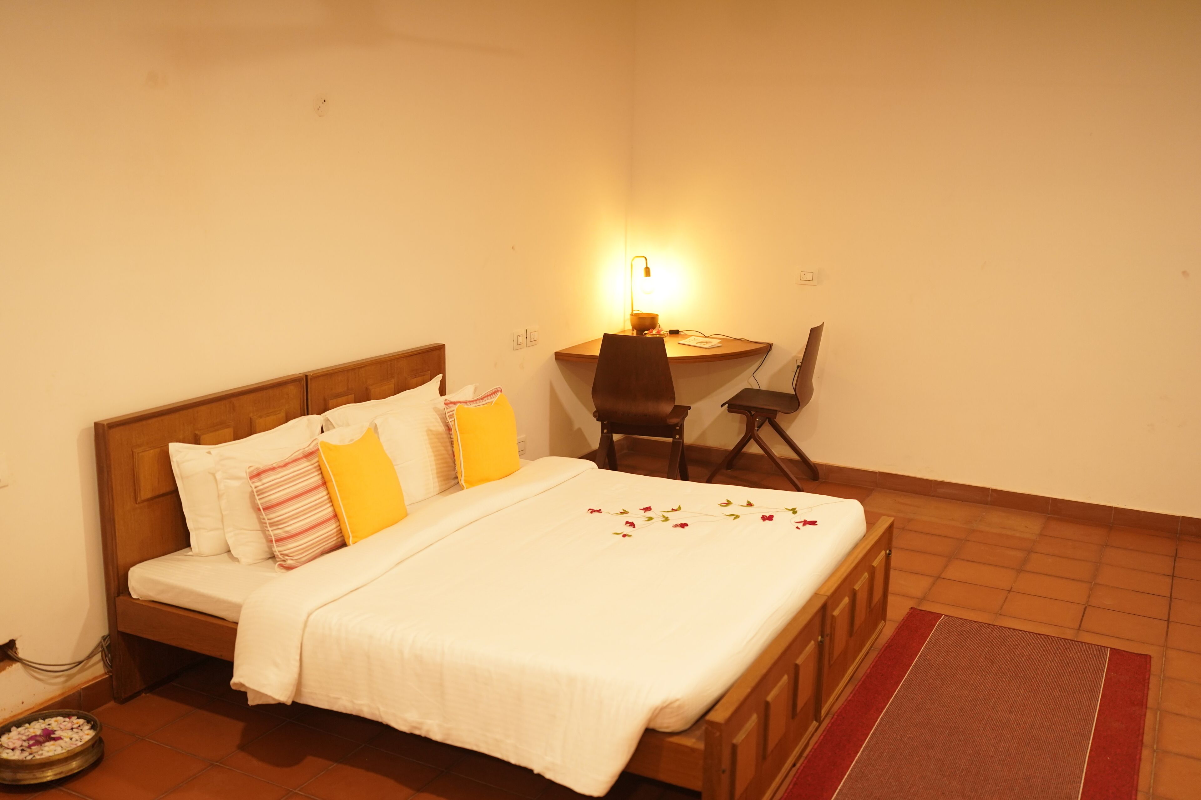 A bedroom with a wooden bed, a desk, and a chair.