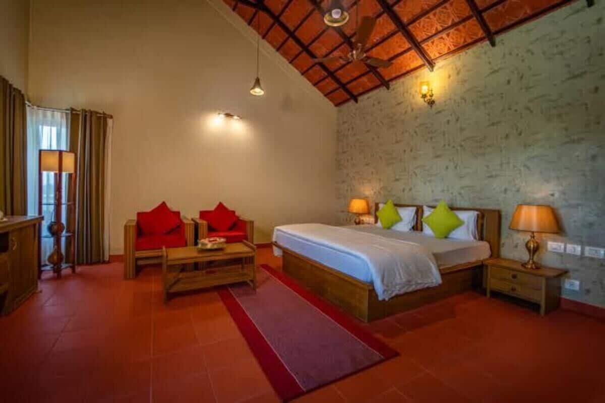 A bedroom with a bed, two bedside tables, a nightstand, a wooden bench, and a red rug.