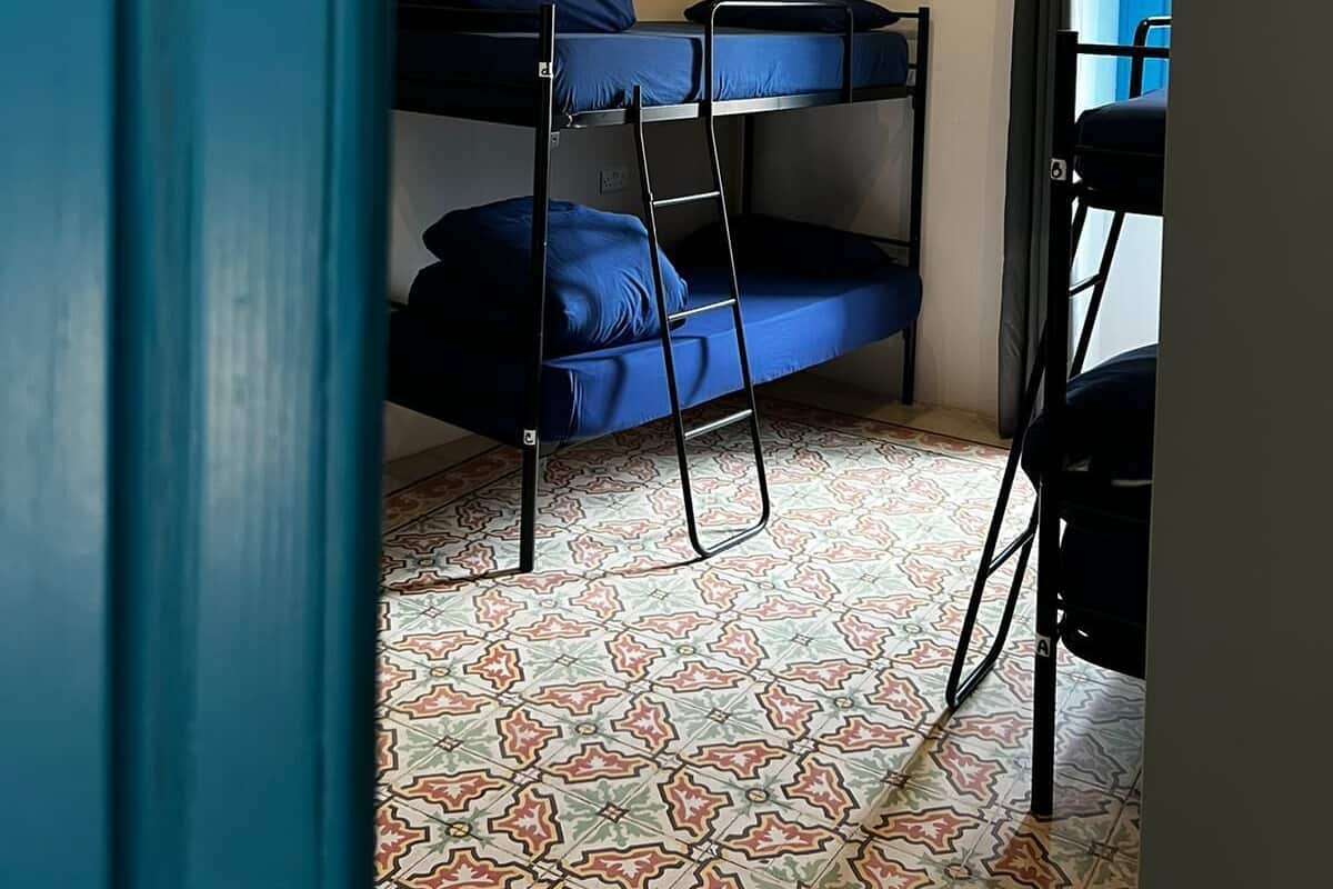 A room with bunk beds, a patterned floor, and a door labeled '8'.