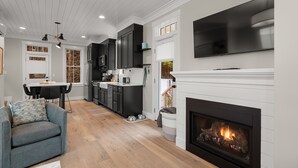 A modern kitchen with dark cabinets, a white countertop, and a built-in oven. - Seabrook Robins Nest | Pet Friendly, Hot Tub | 2BR, Sleeps 5, A/C (Pacific Beach)