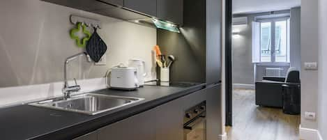 Comfort Apartment | Private kitchen | Full-sized fridge, microwave, oven, stovetop