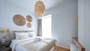 A modern bedroom with a large bed, bedside tables, a wooden bench, and a large window. - Bob W Pärnu (Parnu)