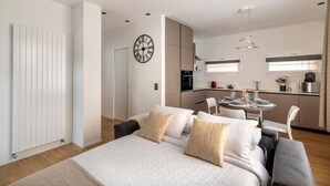 A modern apartment with a bedroom, a dining area, and a kitchen. - Blue Diamond - Gorgeous lakefront apartment with parking (Lugano)