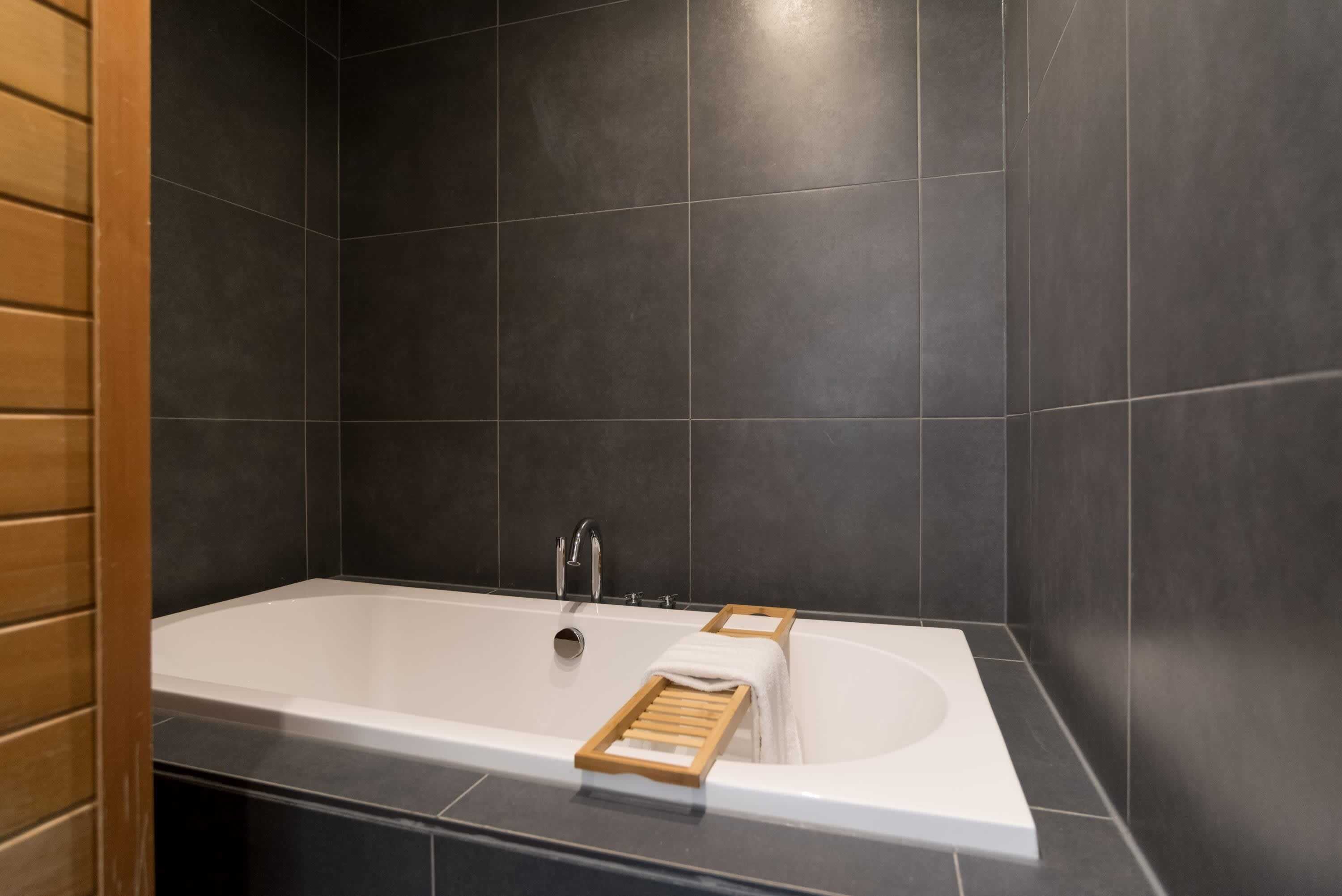 Bathtub, hair dryer, towels, shampoo