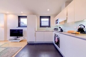 Cozy living space with a kitchenette, flat-screen TV, and modern amenities.