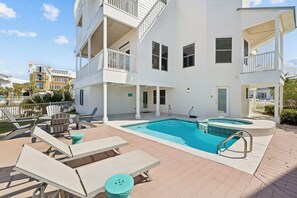 A multi-story building with a swimming pool, outdoor seating, and balconies. - Stunning Lakefront Escape Steps to Beach w/ Pool, Spa, & Gulf-View Rooftop Deck (Seagrove Beach)