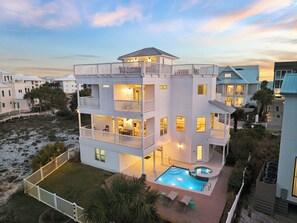 A multi-story beachfront property with balconies, a swimming pool, and a view of the ocean. - Stunning Lakefront Escape Steps to Beach w/ Pool, Spa, & Gulf-View Rooftop Deck (Seagrove Beach)