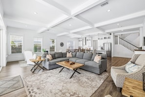 A spacious living room with a sectional sofa, a coffee table, and a dining area with chairs. - Luxury home with private pool, outdoor kitchen w/fireplace & deeded beach access (Seacrest Beach West)