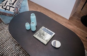 A round table with a book titled 'Historic Photos of Jacksonville,' three cylindrical objects, and a round object.