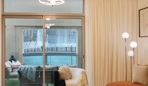 A hotel room with a view of a water fountain and a balcony. - Manzil - Spacious 3B Villa w/ Burj & Fountain View (Dubai)