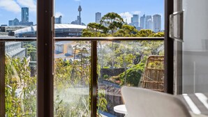 A view from a balcony with a cityscape, including a tall tower and modern buildings. - Prime Location 2-Bed Apartment with Parking (Centennial Park)
