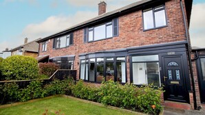 A two-story brick house with a black front door and windows. - Welcoming Family Home - Pass the Keys (North Shields)