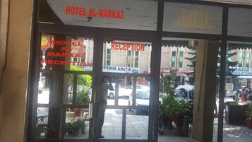 The entrance to Hotel Al-Markaz with a reception area visible through the glass doors.