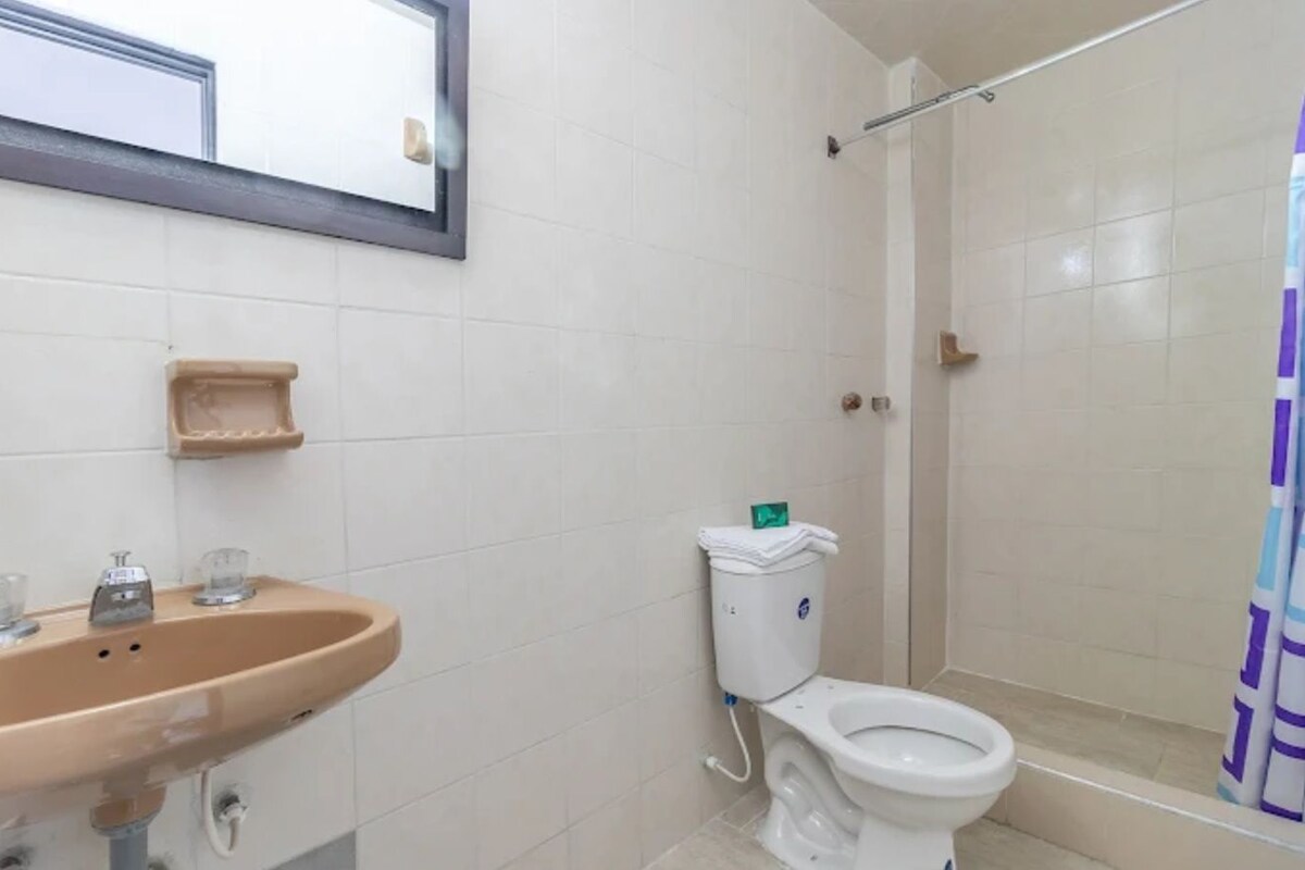 A bathroom with a sink, toilet, and shower.