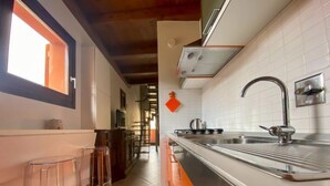 A modern kitchen with a large sink, stainless steel appliances, and a window providing natural light. - Orcagna apartment by Interhome (Florence)
