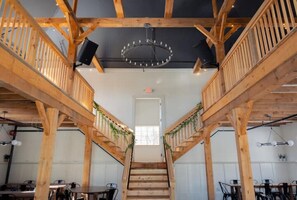 Stairs lead to an upper level, flanked by simple railings and a glass-panelled door.