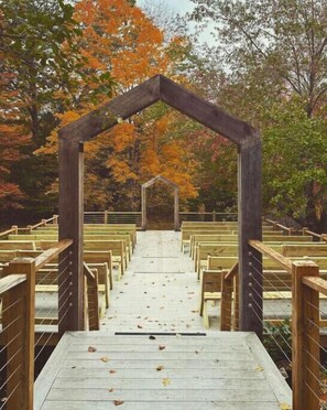 Seating area with wooden benches and archway, perfect for gatherings.
