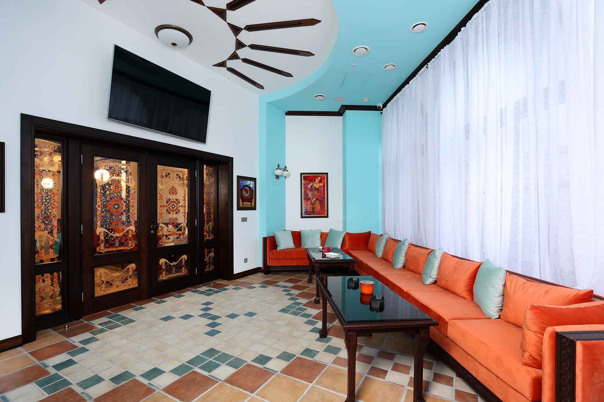 A modern living room with a sofa, a coffee table, and patterned doors.