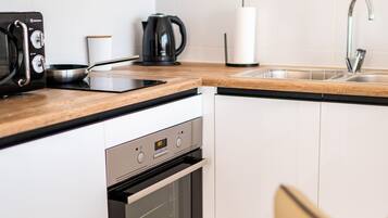 Deluxe Apartment | Private kitchen | Full-size fridge, microwave, espresso maker, coffee/tea maker