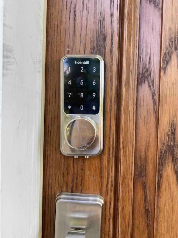 A wooden door with a hornbill brand intercom system installed. - 5 bedroom with parking for families and groups. (Springfield)