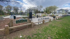 Entrada a un parque con un cartel que dice "Walsh Park" y una valla de madera.