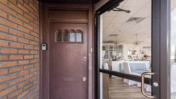 A brown door with a window and a keypad lock. - Bryn Mawr Has It All (Bryn Mawr)