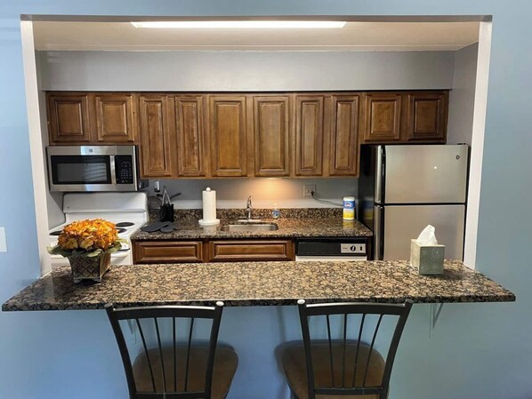 Fridge, coffee/tea maker, cookware/dishes/utensils