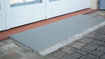A door with a glass panel and a metal threshold.