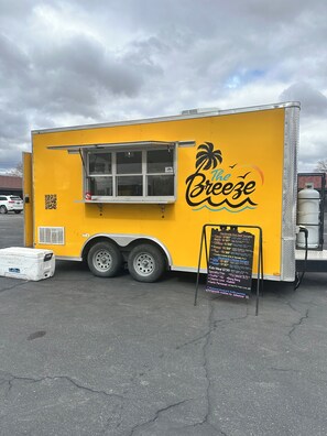 A yellow food truck with a menu board and a QR code. - Vernals Best Value Inn (Vernal)