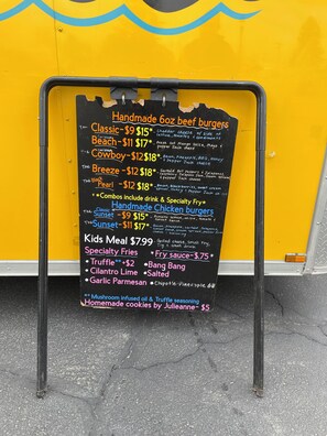 A menu board for a food truck listing various beef and chicken burgers, specialty fries, and a kids meal. - Vernals Best Value Inn (Vernal)