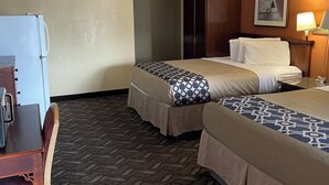 A hotel room with two beds, a desk, a refrigerator, a ceiling fan, and a painting on the wall. - Vernals Best Value Inn (Vernal)