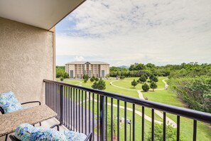 Enjoy a serene view from this balcony overlooking the beautifully landscaped grounds and building complex.