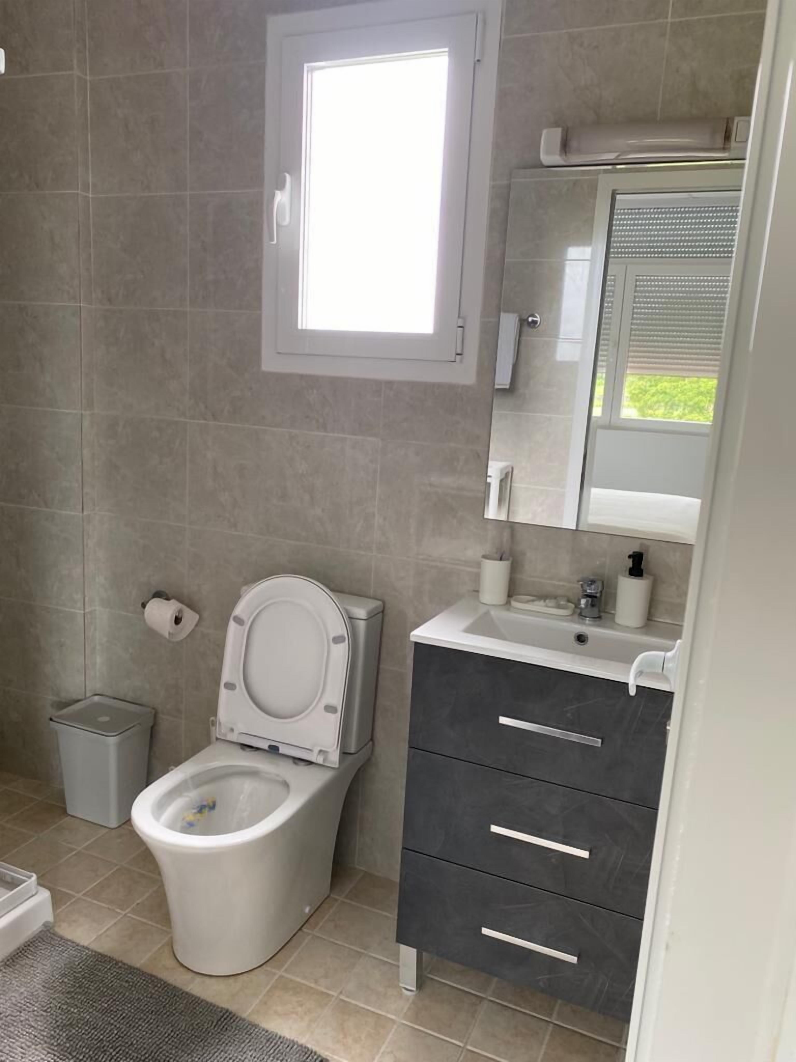 apartment | bathroom | shower, towels, shampoo, toilet paper