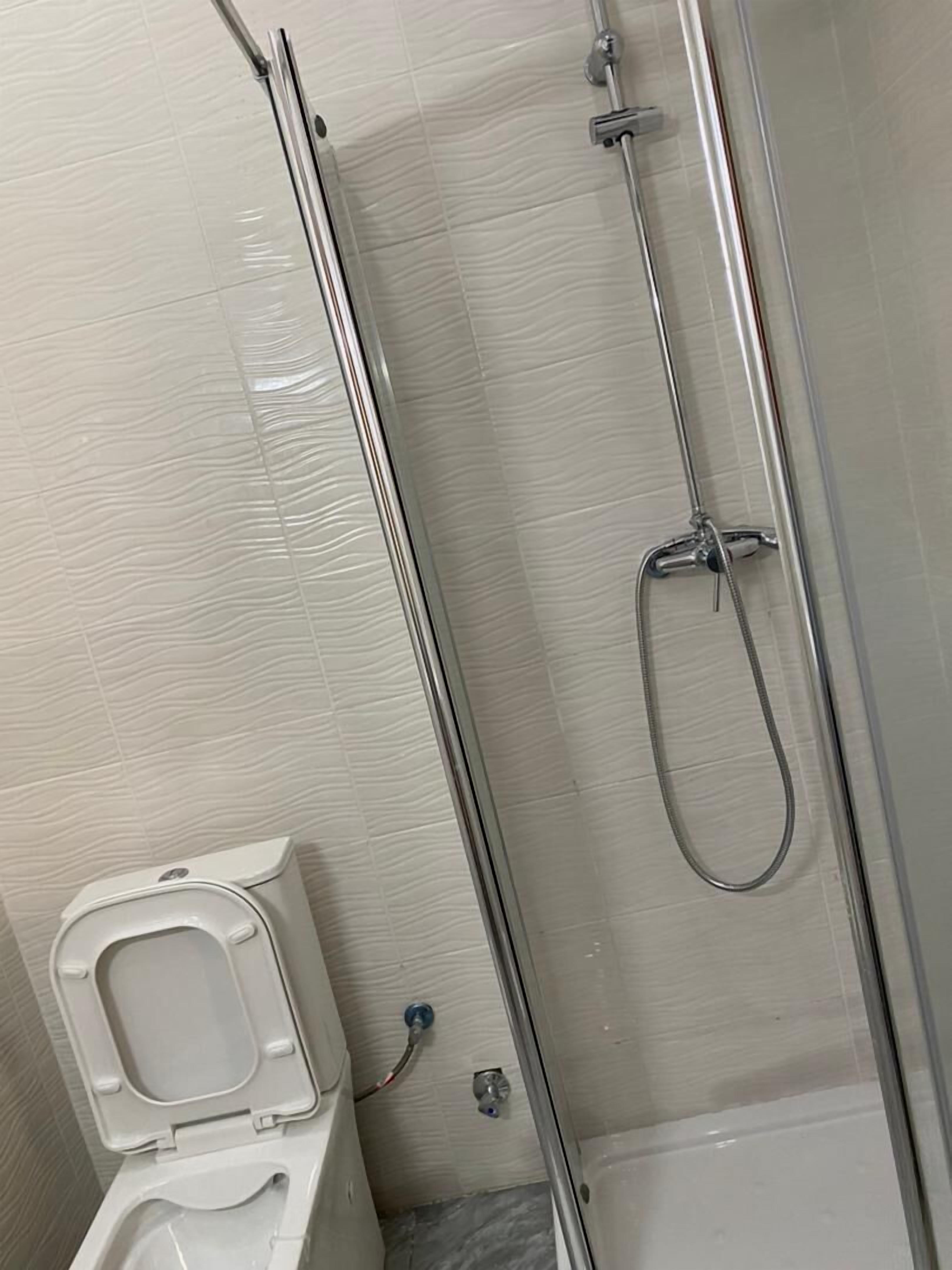 apartment | bathroom | shower, towels, shampoo, toilet paper