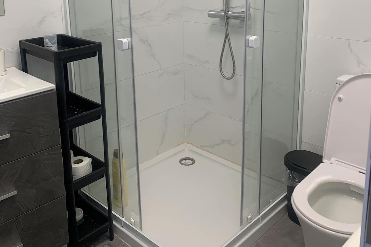 Quarto conforto | Banheiro | Chuveiro, toalhas de banho, shampoo, papel higiênico