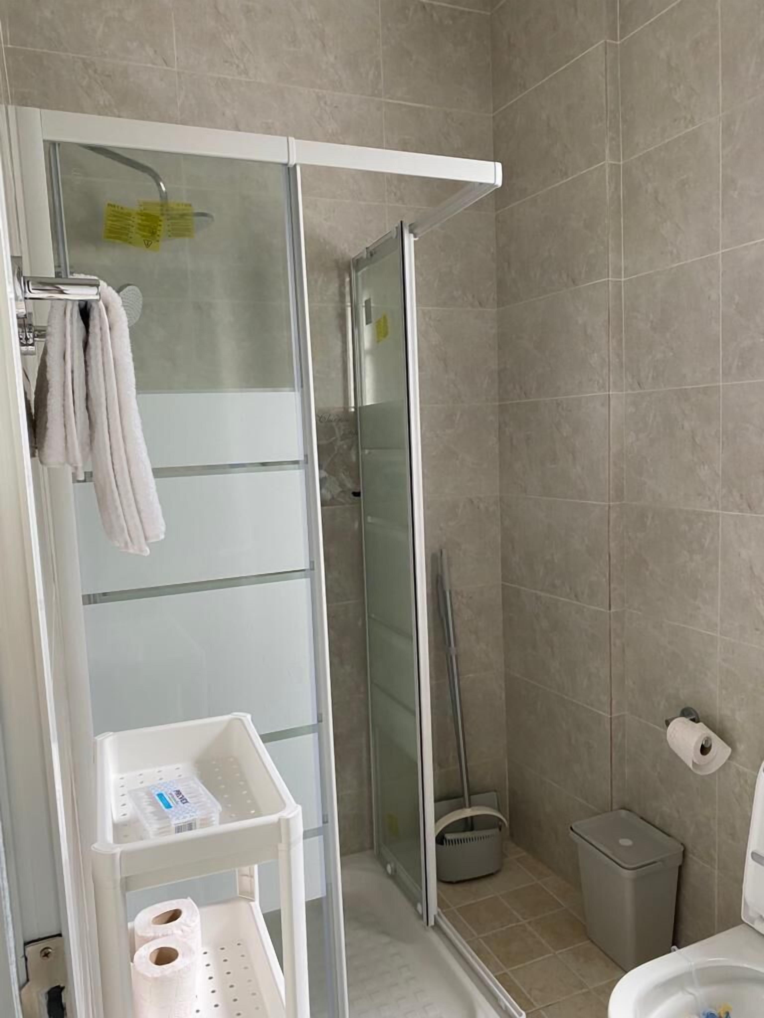 apartment | bathroom | shower, towels, shampoo, toilet paper