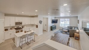 A spacious living area with a kitchen, dining table, and seating area. - Red Rock Oasis! Close to Adventure! Family Friendly! Amazing Pool! (Washington)