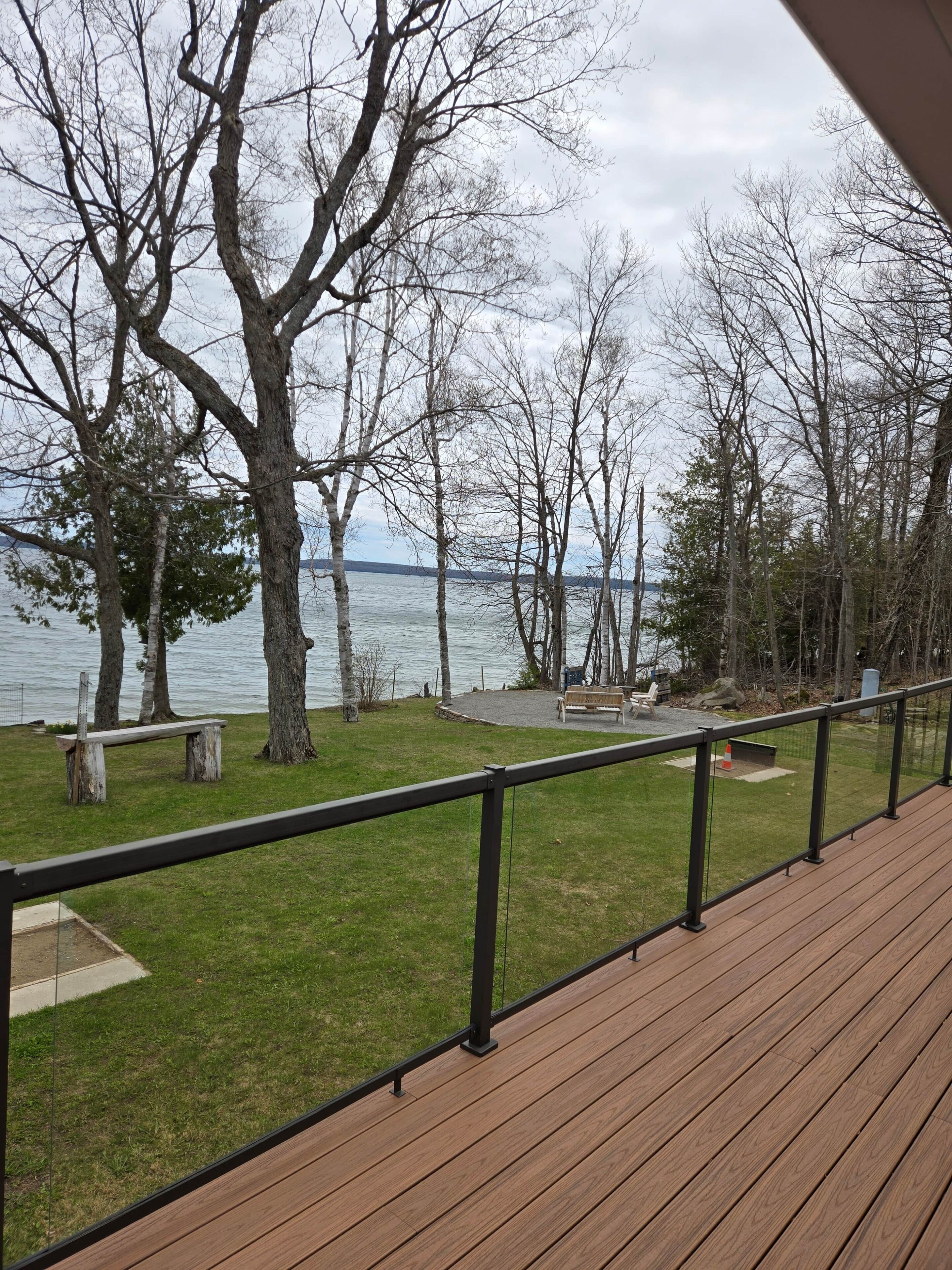 Deck overlooking lake and firepit