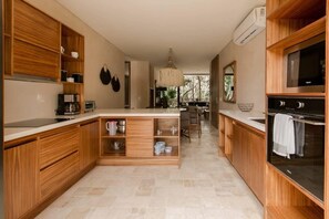 Enjoy cooking in this spacious kitchen with a central island, large stove, and ample natural light.