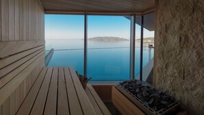 A wooden deck with a view of a calm sea and distant land. - Sea Star Budva (Becici)