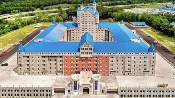 A large, multi-story building with a central tower, surrounded by a well-maintained lawn and a parking area. - 3 bedroom, 2 bath apartment. In Castle! With pool! Close to GR and lakeshore (Grandville)