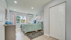 A bedroom with a bed, a wardrobe, a desk, and a window with curtains. - NEW BEACH LISTING-Block To The Beach, Fishing Nearby, Surfing, Chairs (West Palm Beach)