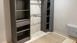 A walk-in closet with multiple shelves and hanging space. - Le nid Capcinois (Formiguères)