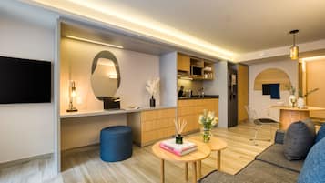 A modern living room with a sofa, a coffee table, and a dining area with a chair and table.