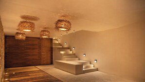 A modern interior with a wooden floor, a staircase, and hanging light fixtures. - Jungle studio (Tulum)