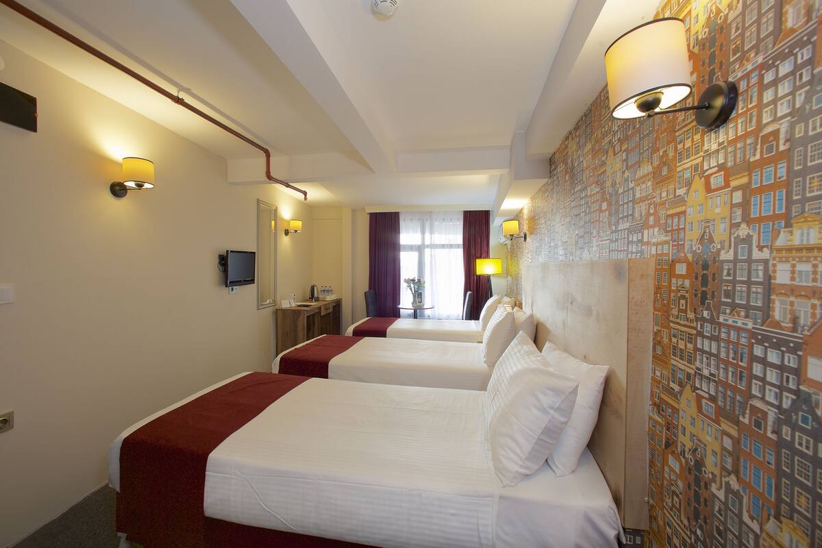 Standard Triple Room | Minibar, iron/ironing board (on request), WiFi (free), bed sheets