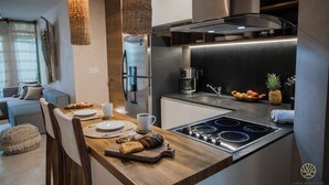 Una cucina moderna con isola in legno, elettrodomestici in acciaio inossidabile e una macchina da caffè.