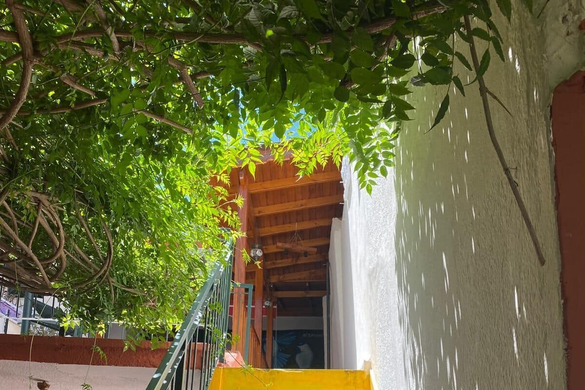 A staircase with colorful steps leading to a wooden door.